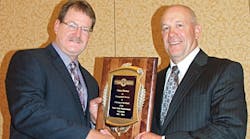 Grant Smith, left, is the new chairman of TTMA. He presents a service appreciation plaque to Glenn Harney, Hyundai Translead, for serving this past year as TTMA chairman.