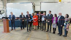 Norb Markert, president and COO of Morgan Truck Body, cuts the ribbon marking the official launch of a new 175,000-square-foot manufacturing facility in Plainfield CT while surrounded by state and local officials.