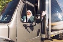 In a new Freightliner eM2, Santa drives away with the native tree seedlings to be donated to TreePeople.