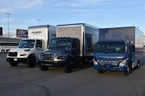 A pair of Freightliner eM2s and a Fuso eCanter were on hand for transportation editors to test drive at the Las Vegas Motor Speedway.
