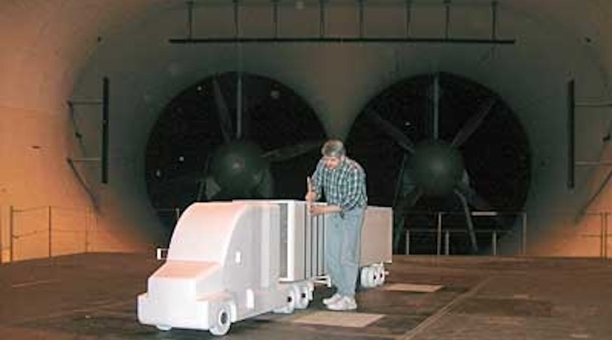 An aerodynamics engineer conducts a wind-tunnel test on a 25-scale model at SOLUS Solutions and Technologies LLC.
