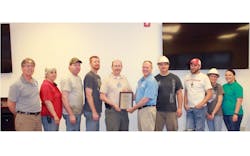 Dale Innis of Liberty Mutual Insurance Risk Control Services presents the Safety Award to a group of UTM39s Paragould AR plant employees representing the plant Dale Innis of Liberty Mutual Insurance Risk Control Services presents the Safety Award to a group of UTM39s Paragould AR plant employees representing the plant
