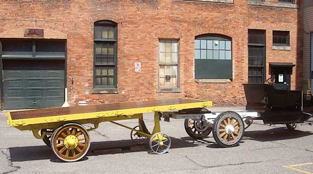 A 1916 Fruehauf trailer with a Smith Form A truck greeted visitors to the Ford Piquette plant. Kits for converting automobiles to pull semi-trailers were common in the early years of the industry.