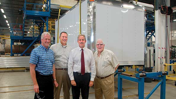 Dave Jarrett Fred Seymour and Ray Doll welcome back Larry McQuoid left who started Multivans in 1962 They are shown in front of one of the three production lines in the new 125000sqft Multivans plant in Bolton Ontario