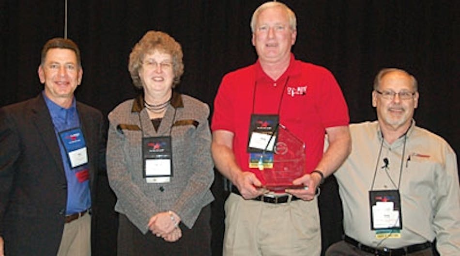 Ron Yarnell, PPG Industries, left, and NATM President Gary Potter, right, present this year&rsquo;s NATM Green Award to Mr. and Mrs. Greg Snyder of Car Mate Trailers.
