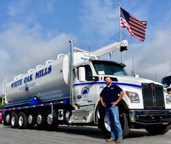 Josh Long White Oak Mills transportation manager stands beside a Kenworth T880S 7axle configuration with 26foot Walinga feed body Josh Long White Oak Mills transportation manager stands beside a Kenworth T880S 7axle configuration with 26foot Walinga feed body
