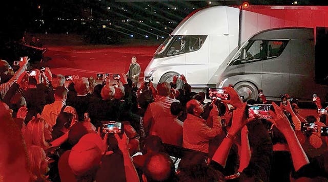 Tesla CEO Elon Musk wows the crowd with a pair of the company&rsquo;s electric trucks.