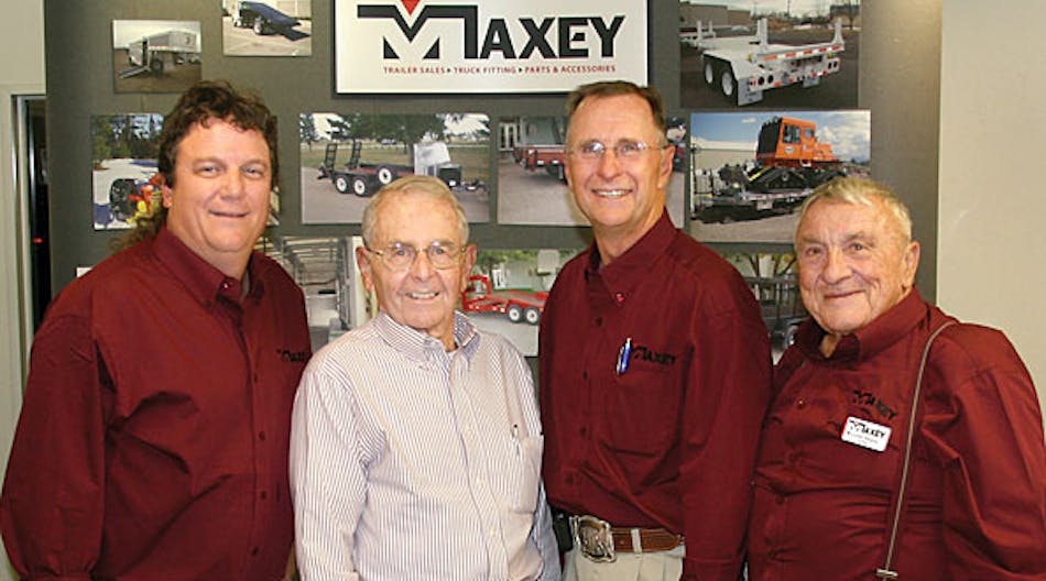 Celebrating the sale of Maxey Companies to MGS Inc are Andy Gehman, MGS Inc, and Fred Urben, Carl Maxey, Loren Maxey, Maxey Companies.