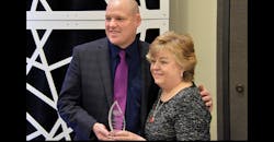 NATM President Patrick Jennissen presents the Outstanding Service Award to outgoing Executive Director Pam Trusdale.