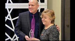 NATM President Patrick Jennissen presents the Outstanding Service Award to outgoing Executive Director Pam Trusdale.