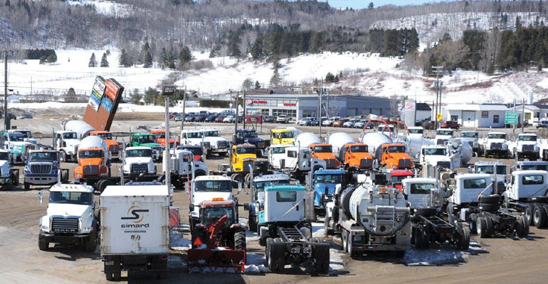 At Simard vehicles awaiting work or shipping are stored outside tagged and lined neatly