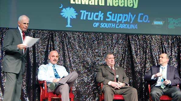 Stu MacKay president of MacKay amp Company asks a question of his panel of distributors Mike McKay director of parts operations for Kenworth Sales Company Edward Neeley owner of Truck Supply Company and Geoff Garafola vicepresident of Inland Truck Parts