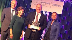 EkoStinger CEO Parr Wiegel holds a Clean Energy Competition trophy after his company claimed the $1 million grand prize in New York.