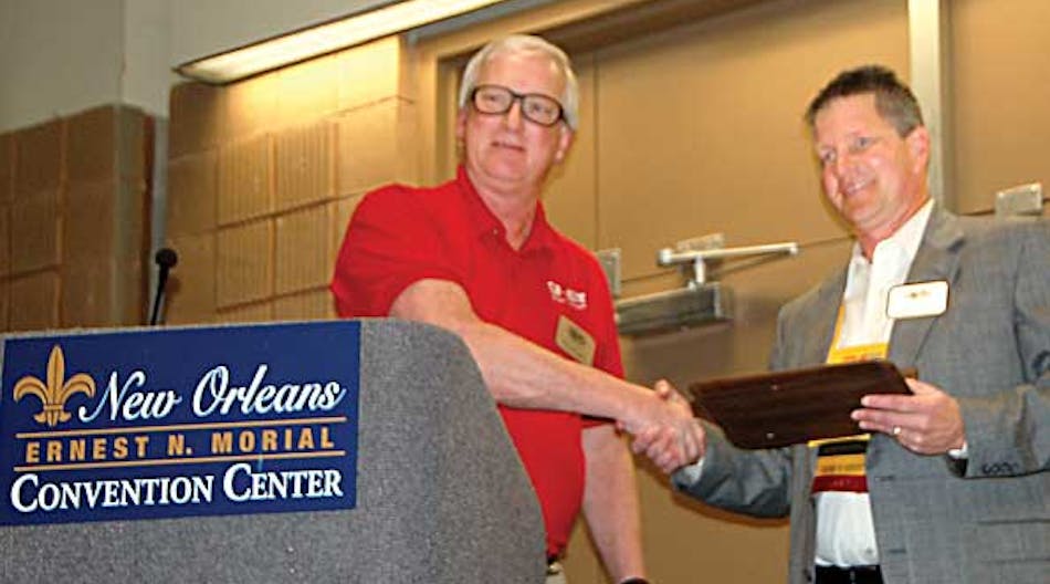 Greg Snyder, incoming NATM president, presents Mike Lloyd with a plaque for his service as the association&rsquo;s president.
