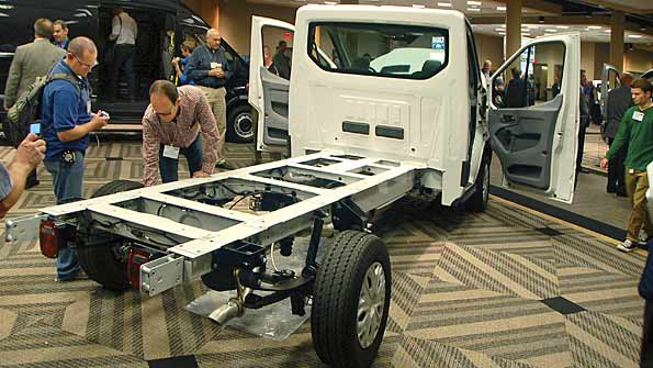 NTEA members scrutinize the frame of a new Ford Transit chassis