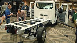 NTEA members scrutinize the frame of a new Ford Transit chassis NTEA members scrutinize the frame of a new Ford Transit chassis