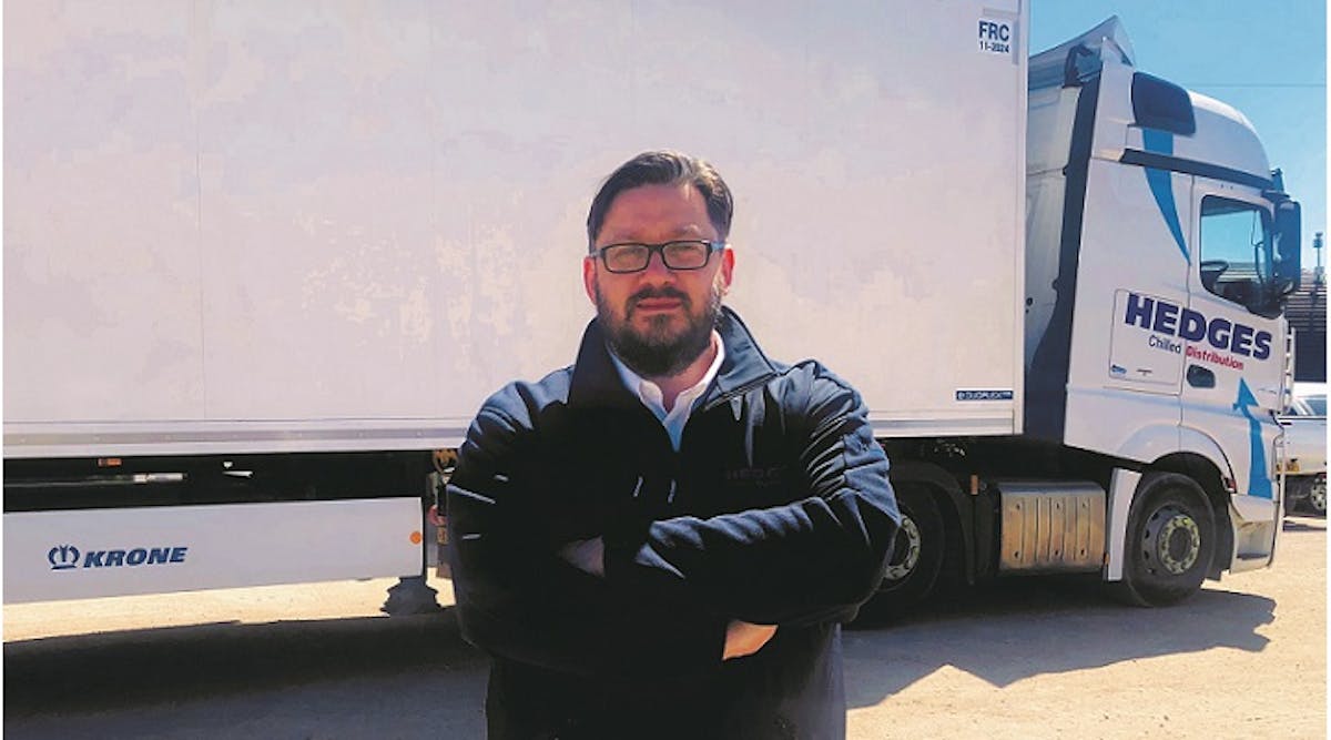 Ciaron Reynolds, Hedges&apos; distribution manager, stands in front of his company&apos;s Krone Cool Liner trailer.