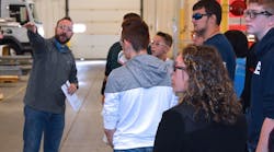 Collin Seigle, production supervisor at Spartan Motors, guides students from Charlotte High School&rsquo;s STEM program around company headquarters in Charlotte MI.