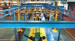 The new production line at CIE Manufacturing in South Gate CA features five stations, with overhead cranes to convey the starting chassis frame on its journey to a completed, fully equipped and inspected intermodal container trailer. The new production line at CIE Manufacturing in South Gate CA features five stations, with overhead cranes to convey the starting chassis frame on its journey to a completed, fully equipped and inspected intermodal container trailer.