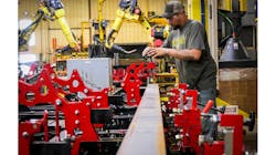 A Felling Trailers production operator stages the fixture for the next gantry robot program run. A Felling Trailers production operator stages the fixture for the next gantry robot program run.
