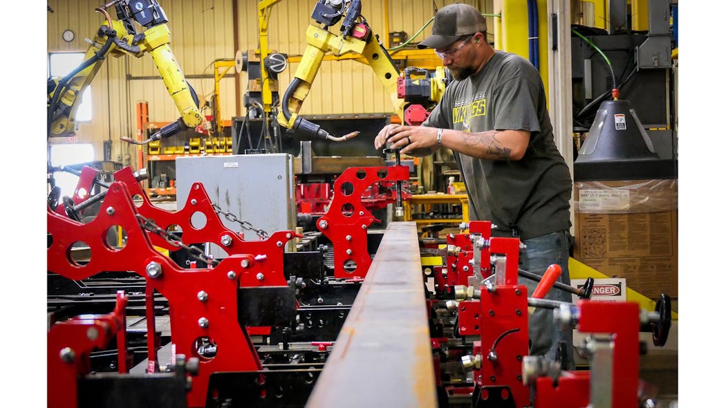 A Felling Trailers production operator stages the fixture for the next gantry robot program run.