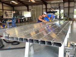 The interlocking extrusions, secured with Huck bolts, remove the need for welding and greatly reduce the skilled labor and time required to assemble dumps built with the patented system. The interlocking extrusions, secured with Huck bolts, remove the need for welding and greatly reduce the skilled labor and time required to assemble dumps built with the patented system.