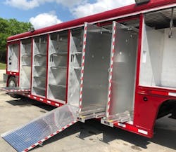 The refurbished trailer features loading ramps and slide-out panels for hanging hand tools.