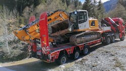A Goldhofer Liebherr R918 crawler excavator is transported to a remote Austrian gorge by a 3-axle semi lowloader. A Goldhofer Liebherr R918 crawler excavator is transported to a remote Austrian gorge by a 3-axle semi lowloader.