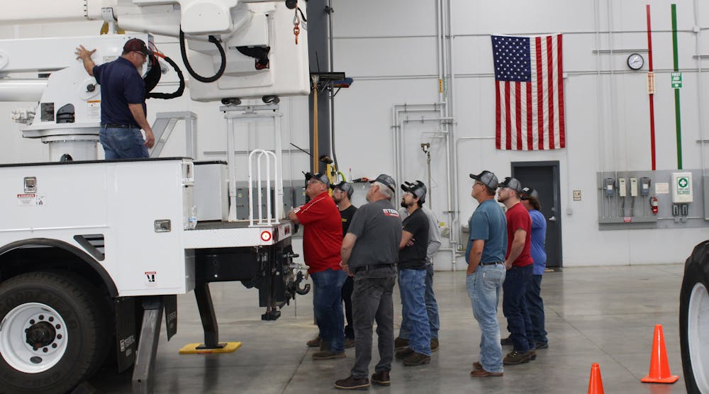 Technicians listen during a demonstration at Terex Utilities&apos; service training.