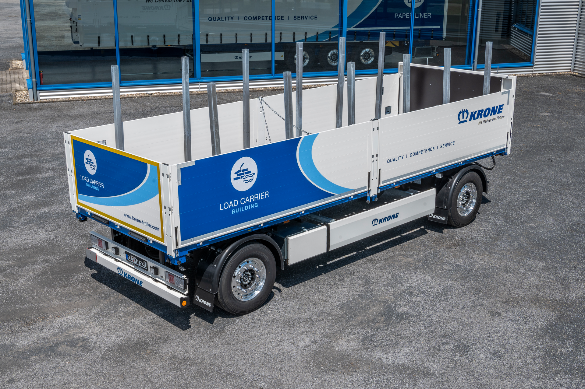 The Krone 'Load Carrier Building' is a two-axle trailer designed for transporting a wide variety of building materials.