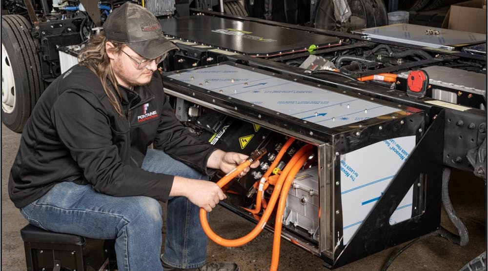 A Fontaine Modification technician routes high-voltage wiring on a chassis at the company&rsquo;s modification center in Mineral Wells, West Virginia.