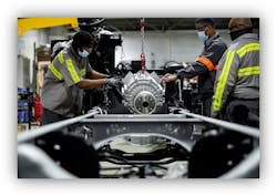 Technicians at the Fontaine Modification Center in Detroit, Michigan, install an electric motor assembly into a Class 6 chassis. Technicians at the Fontaine Modification Center in Detroit, Michigan, install an electric motor assembly into a Class 6 chassis.