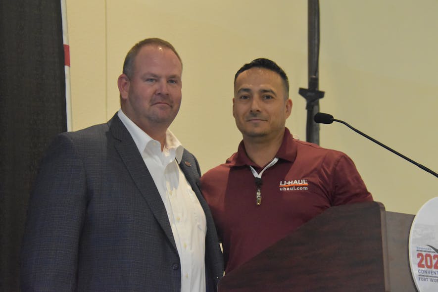 Outgoing NATM President Marty Lorick, owner of Triple Crown Trailers, passes the reins to 2023 President Marco Garcia, director of engineering services at U-Haul International.