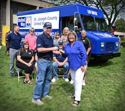 The Morgan Olson team hands the keys of the new step van to Kelly Hostetler, the executive director of the St. Joseph County United Way.