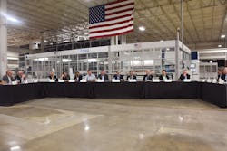 The roundtable convenes on the shop floor of a Stoughton Trailers production facility, just in front of a robotic welding cell. The roundtable convenes on the shop floor of a Stoughton Trailers production facility, just in front of a robotic welding cell.