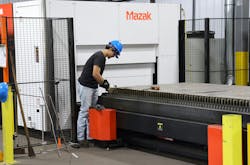 Cristobol Reza, Kalyn Siebert lead programmer and laser operator, works with the new Mazak Optiplex Neo 3015 laser processing machine. Cristobol Reza, Kalyn Siebert lead programmer and laser operator, works with the new Mazak Optiplex Neo 3015 laser processing machine.