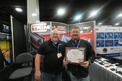 Brady Russell, left, and Tyler Newman accept the Trailer Trends & Tech Showcase award for Optronics at this year's NATM convention. Brady Russell, left, and Tyler Newman accept the Trailer Trends & Tech Showcase award for Optronics at this year's NATM convention.