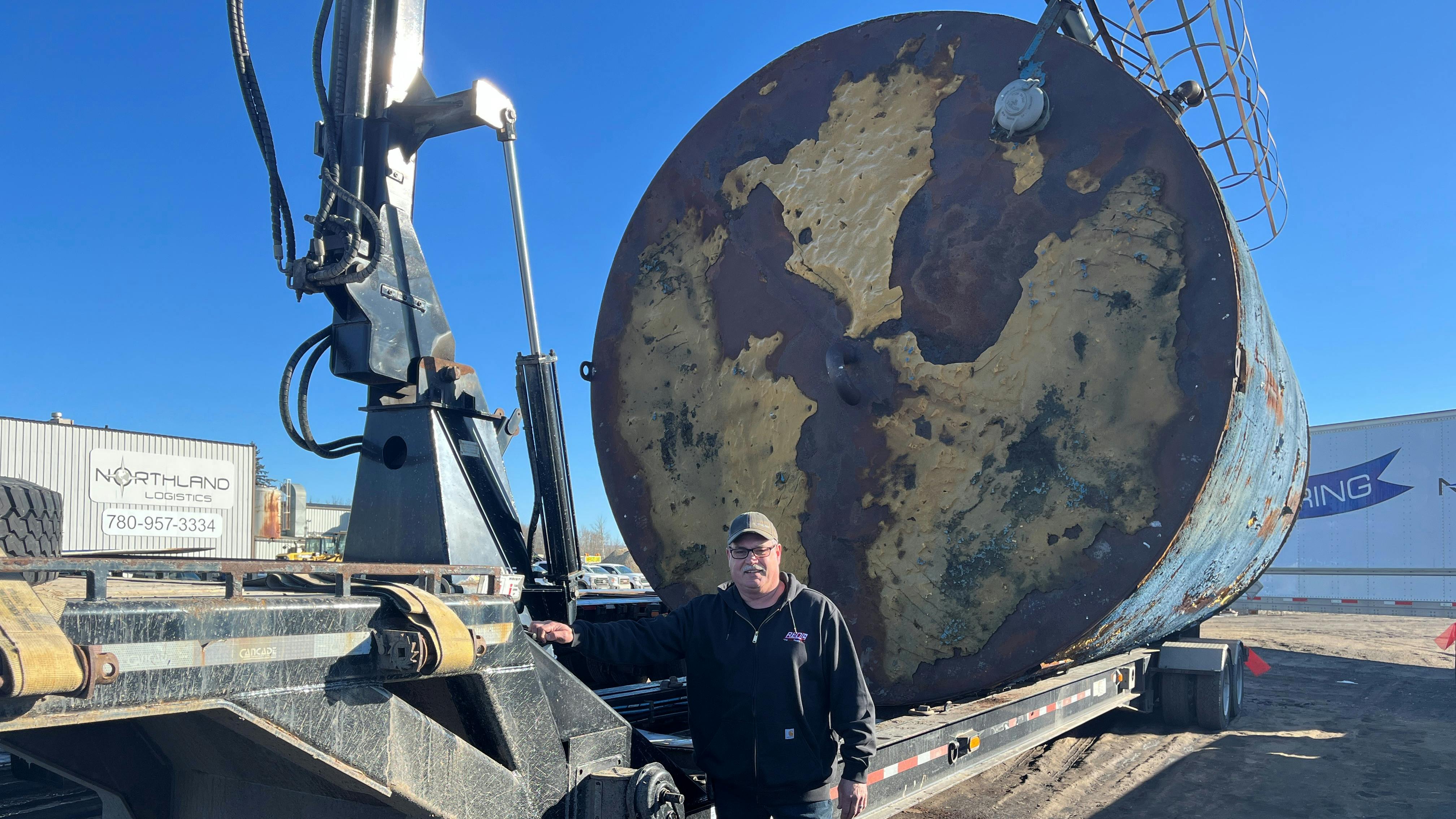 Roger Keddy from Northland Logistics stands beside one of many heavy hauling trailers equipped with Continental Hydraulic Hose. These trailers are used for extensive transportation for a variety of equipment.