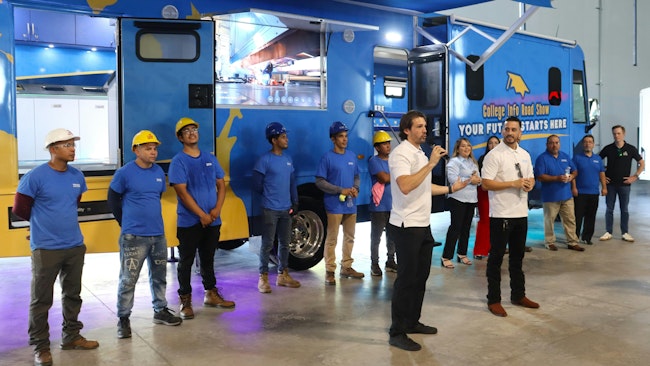 Marco Novo, Truck Builders and Chef Units founder and CEO, front left, and Alfonso Logo, Truck Builders vice president, front right, spotlight their team and specialty vehicle capabilities during a special event Oct. 14 in Houston.